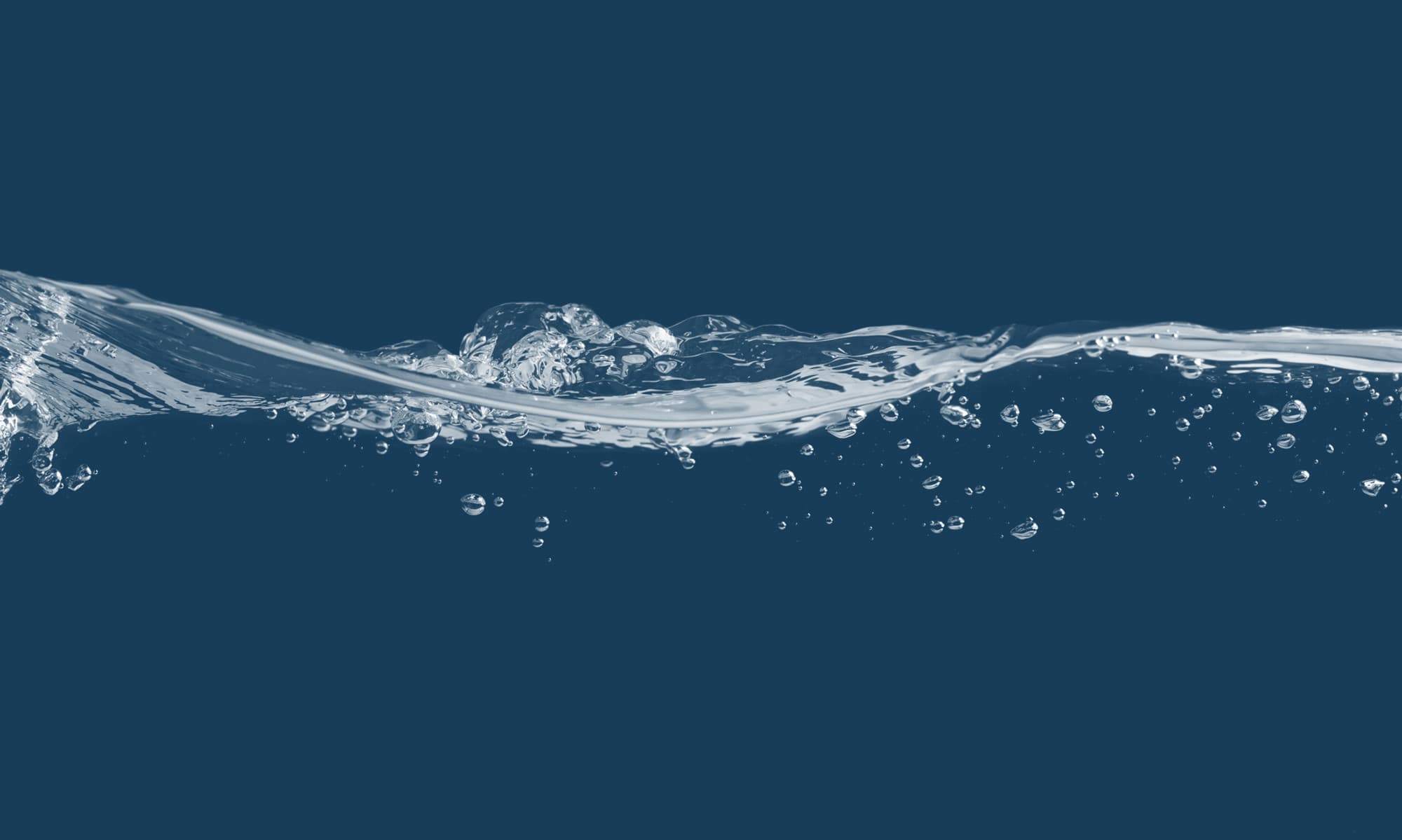 Clear water in motion against a deep blue background